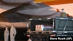 A transfer case containing the body of Maj. Brent Taylor sits on a loader at Dover Air Force Base in Delaware on November 6, 2018.