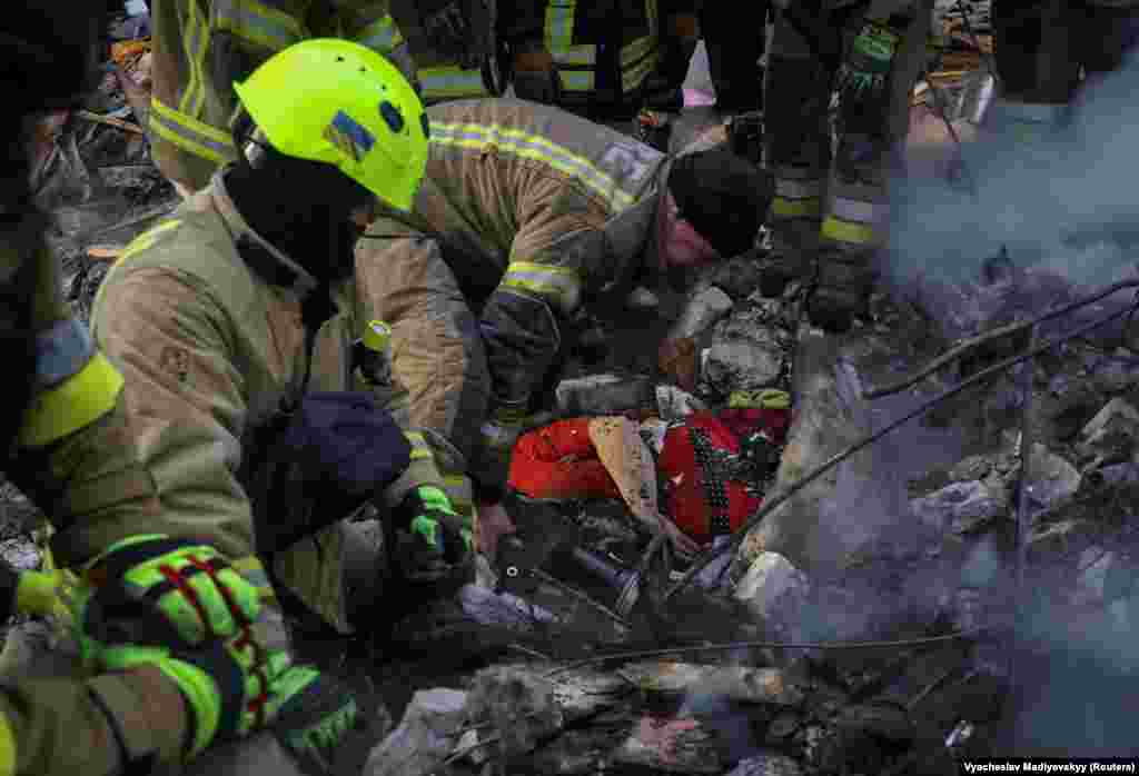 Рятувальники дістають з-під завалів тіло жінки, загиблої внаслідок російського удару. Харків, 7 березня 2026 року