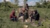 SERBIA - A group of migrants rest in a field near the Serbian village Majdan, close to the Hungary and Romania borders, on May 21, 2021