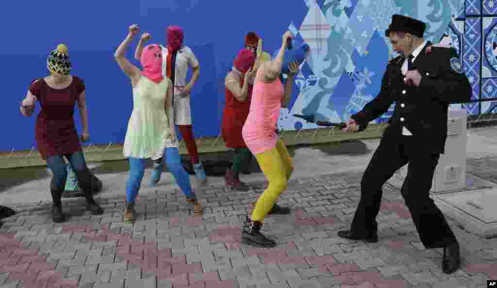 A Cossack militiaman attacks Nadezhda Tolokonnikova and other members of the punk protest group Pussy Riot as they performed on a street in Sochi, Russia, on February 19. (Morry Gash, AP)