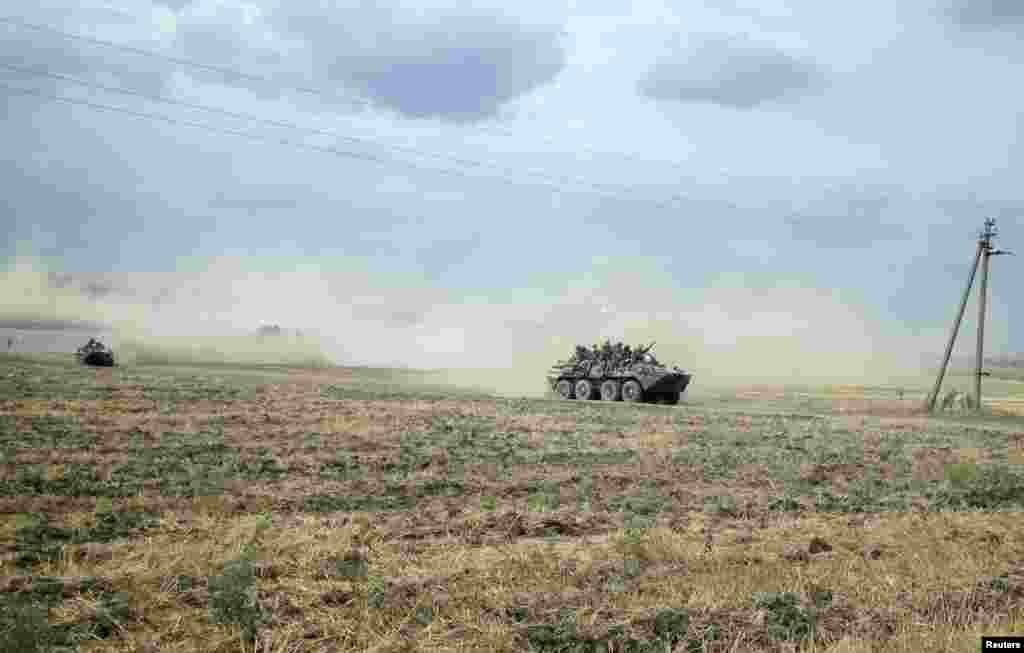 Russian servicemen sit atop an armored vehicle as they travel near the village of Krasnodarovka in the Rostov region near the Ukrainian border on August 28. (Reuters/Maria Tsvetkova)