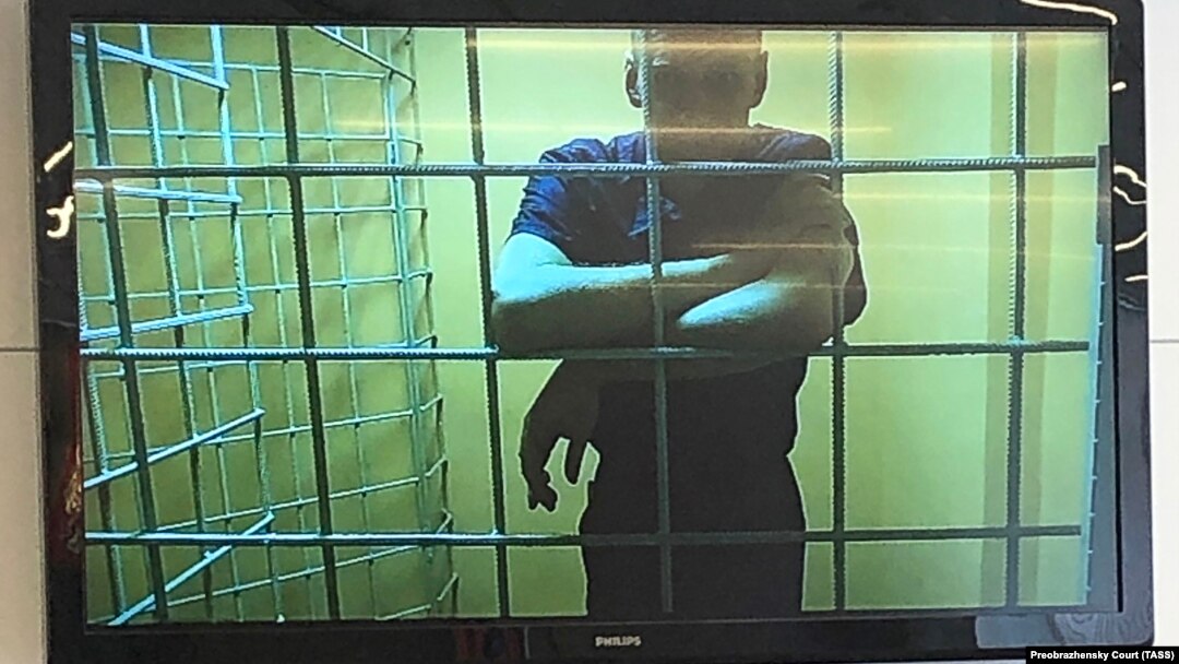 Russian opposition leader Aleksei Navalny is seen on a screen via a videolink during a court hearing in Moscow on June 22.