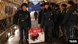 Workers in Moscow load gasoline-powered generators into an Ilyushin IL-76 airlifter belonging to Russia's Emergency Situations Ministry before sending them to Crimea on November 24.