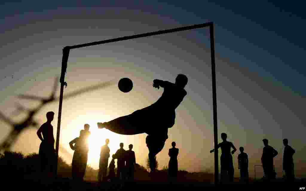 Afghan kids play soccer on a field in Herat Province. (AFP/Aref Karimi)