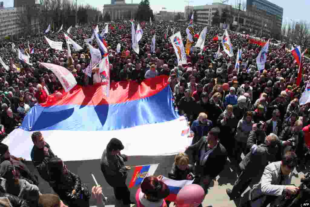 Pro-Russian protesters hold Russian national flags during a rally in the eastern Ukrainian city of Donetsk on April 6.