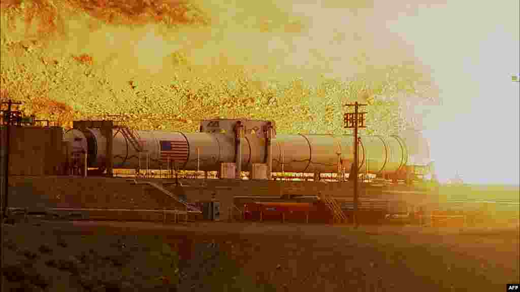 A NASA photo shows the largest, most powerful rocket booster ever built successfully fired up on March 11 for a major ground test in preparation for future missions to help propel NASA’s Space Launch System (SLS) rocket and Orion spacecraft to deep space destinations, including an asteroid and Mars. (AFP via NASA)