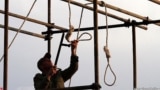 An Iranian soldier prepares a noose for a public hanging (file photo)