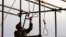 An Iranian soldier prepares a noose for a public hanging (file photo)