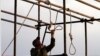 A soldier prepares a noose for a public execution. The recent hanging of 16 Baluch "bandits" is contributing to a cycle of violence. 