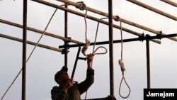 An Iranian soldier prepares a noose ahead of a public hanging. Will watching a video of such a hanging spur opposition to the practice, or just desensitize the viewer?