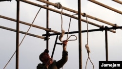 An Iranian soldier prepares a noose ahead of a public hanging. (file photo)