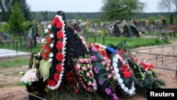 A freshly dug grave is seen at the Vybuty cemetery in the Pskov region on August 27.