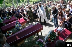 Relatives and friends attend a funeral ceremony for pro-Russian rebels who were killed during fighting in the town of Maryinka on June 6.
