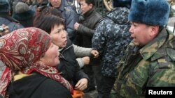 Kiosk operators argue with police during a protest in Bishkek on March 17.