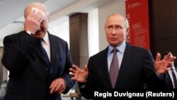 Russian President Vladimir Putin (right) gestures as Belarusian President Alyaksandr Lukashenka mops his brow during a meeting in the Black sea resort of Sochi in February.