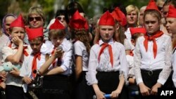 Ukraine - Children in red caps and ties, inspired by the Soviet Pioneers movement, taking part in a meeting of the youth movement "Patriot", an organization of the self-proclaimed People's Republic of Donetsk (DNR) in the outskirts of Donetsk, May 26, 201