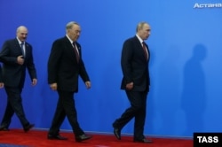 Президент Беларуси Александр Лукашенко, президент Казахстана Нурсултан Назарбаев и президент России Владимир Путин (слева направо) после церемонии подписания договора о создании ЕвразЭС. Астана, 29 мая 2014 года.