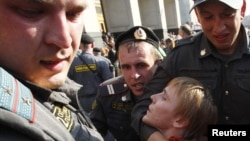 Police detain an opposition protester at a rally in Moscow on May 31