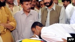 An activist kisses the body of nationalist leader Habib Jalib Baloch, who was shot by gunmen in an attack in Quetta on July 14.