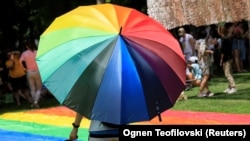A person walks with a rainbow umbrella in the second Gay Pride parade in Skopje, North Macedonia, on June 26. 