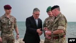 British Prime Minister Keir Starmer meets military personnel on a beach in Bahrain on April 9 during a three-day visit to the region.