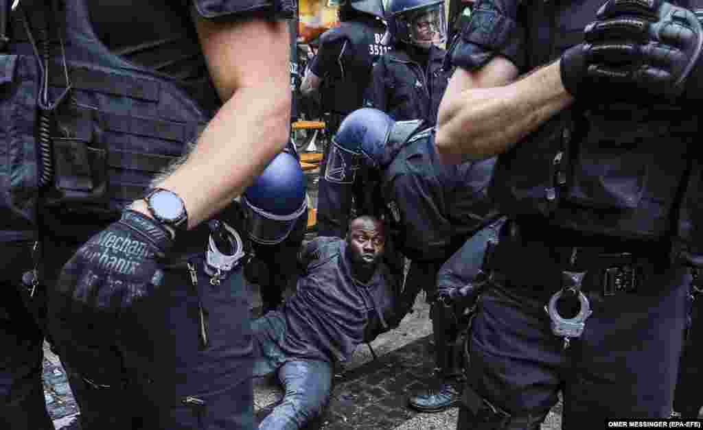 German police officers detain a man following a Black Lives Matter vigil at Alexanderplatz square in Berlin, Germany 06 June 2020. Some scuffles between police and protests took place after the main demonstration has ended.