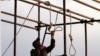 An Iranian soldier prepares a noose ahead of public hanging. (file photo)