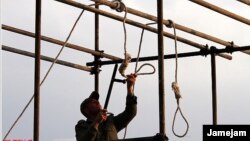 A soldier prepares a noose for a public execution. The recent hanging of 16 Baluch "bandits" is contributing to a cycle of violence. 