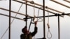 An Iranian soldier prepares a noose ahead of a public hanging. Will watching a video of such a hanging spur opposition to the practice, or just desensitize the viewer?