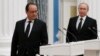 Russian President Vladimir Putin (R) and his French counterpart Francois Hollande arrive to hold a press conference after their meeting in Moscow on November 26, 2015.