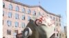 Armenia -- An enviromental activist wears a gas mask outside the Administative Court in protest against a controversial mining project, 23 March 2010.