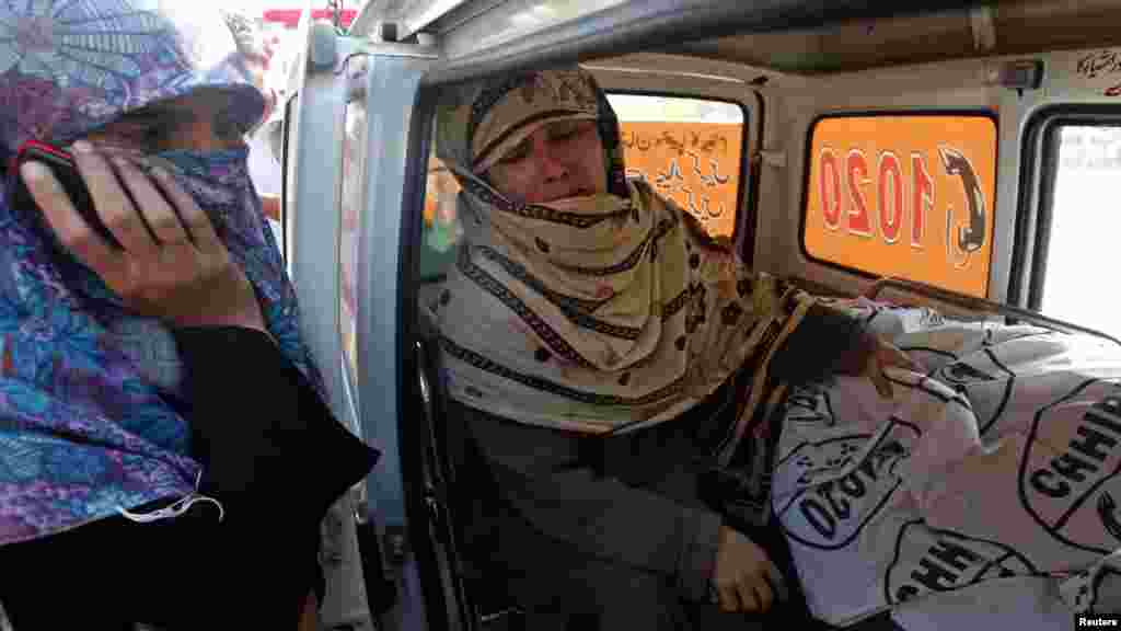 Rukhsana Bibi weeps next to the body of her daughter Madiha, a slain polio-eradication worker, in an ambulance outside Jinnah Hospital in Karachi on December 18. (Reuters/Akhtar Soomro)