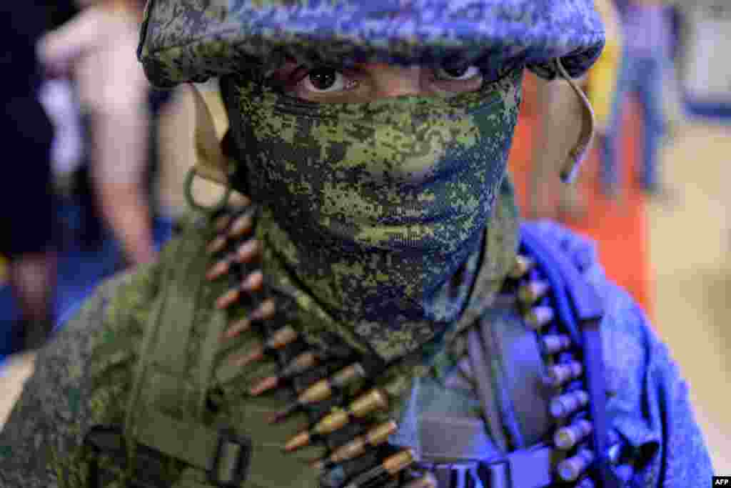 A participant poses for a photo during the Interpolitex-2015 exhibition of police and military equipment in Moscow on October 22. (AFP/Kirill Kudryavtsev)