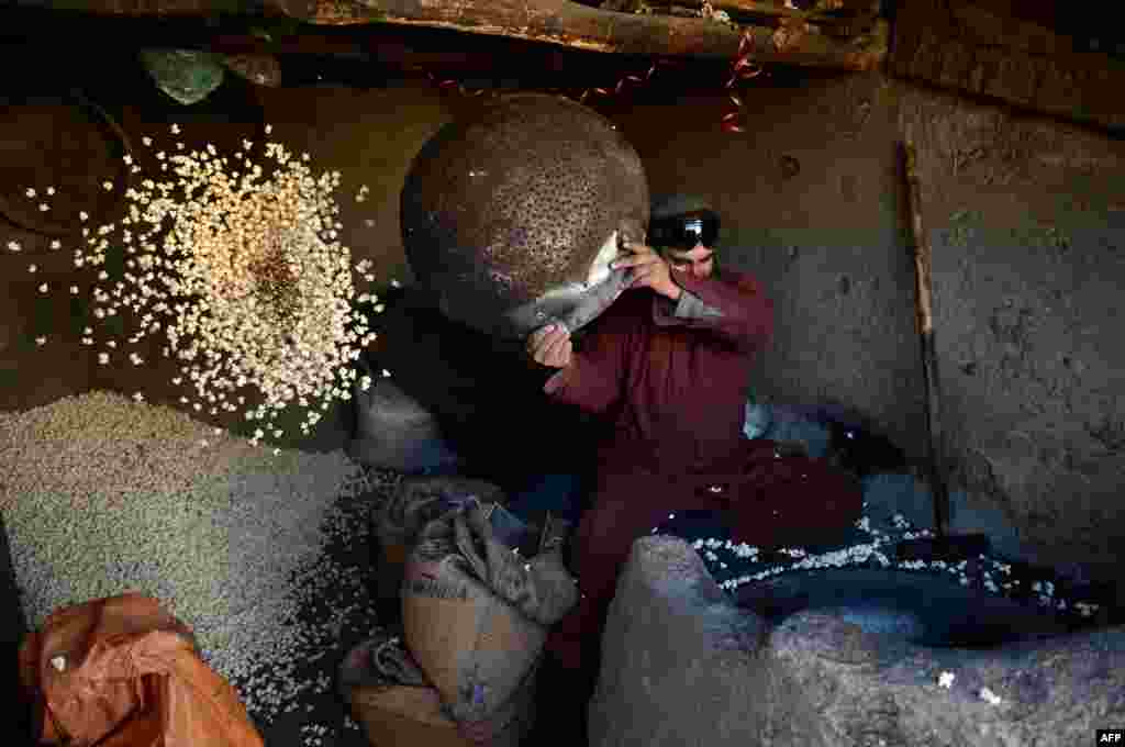 A popcorn vendor works inside his shop in Kabul. (AFP/Wakil Kohsar)