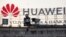A surveillance camera is seen in front of a Huawei logo in Belgrade, Serbia. (File photo)