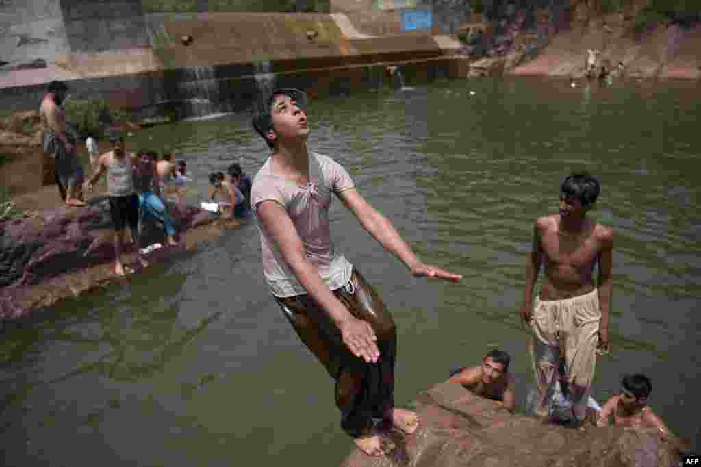 Pakistani youths cool off in a river as temperatures reached around 43 degrees Celsius on the outskirts of Islamabad on June 5. (AFP/Aamir Qureshi)