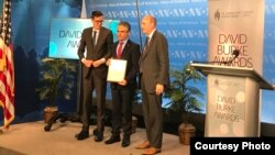 RFE/RL Afghan Service Director Qadir Habib accepts the David Burke Journalism Award on behalf of Radio Azadi.