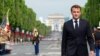 France - France's President Emmanuel Macron walks on the day of the annual Bastille Day military parade on the Champs-Elysees avenue in Paris, July 14, 2023. 
