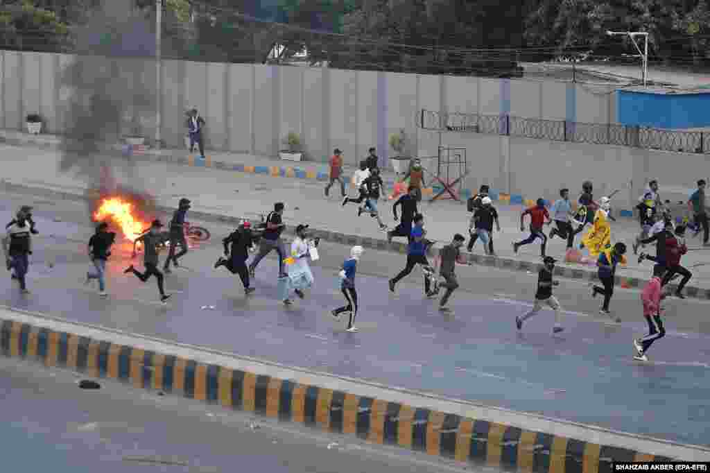 Flames rise from a motorcycle set on fire during a rally in Karachi, Pakistan, to protest the killing of Hezbollah leader Hassan Nasrallah.