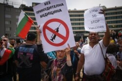 Protesters hold banners against the 5G technology and vaccines at an anti-government protest in front of the parliament in Sofia, Bulgaria, on May 14.