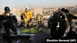 Iran -- Debris is seen from an Ukrainian plane which crashed as authorities work at the scene in Shahedshahr, southwest of Tehran, January 8, 2020. 