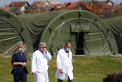 Medical personnel are seen near military tents that were assembled for future coronavirus patients at Dubrava hospital in Zagreb, Croatia.