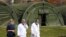 Medical personnel with face masks are seen near military tents which are built for patients who will have coronavirus disease (COVID-19) at Dubrava hospital in Zagreb