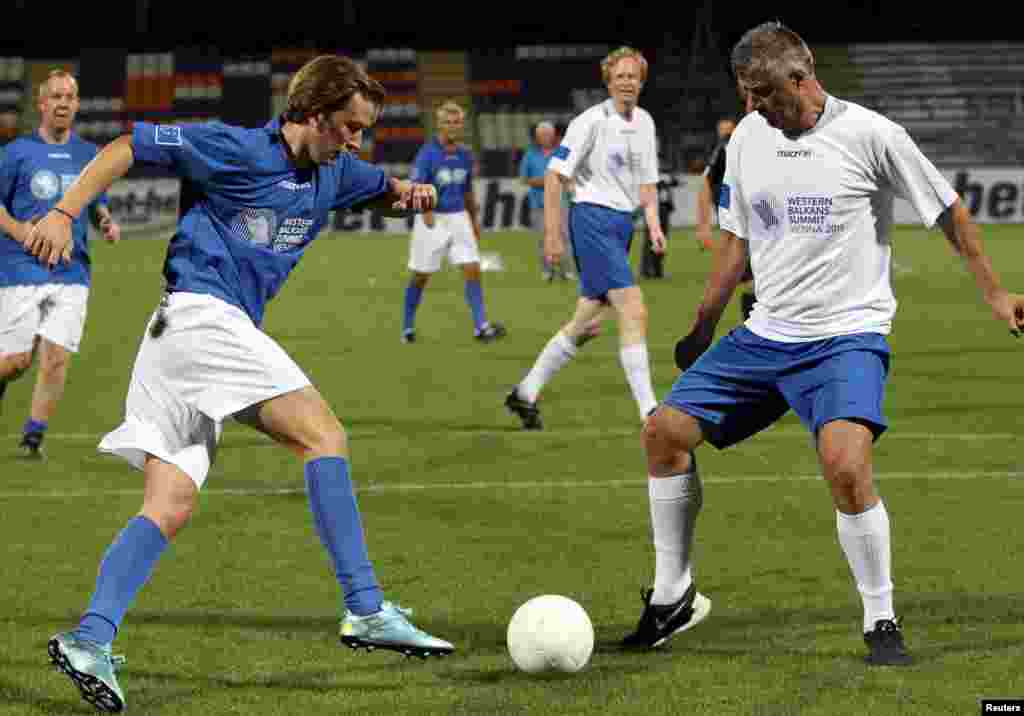 Austrian Foreign Minister Sebastian Kurz (left) and Kosovar Foreign Minister Hashim Thaci fight for the ball during a politicians&#39; soccer match ahead of the Western Balkans Summit in Vienna on August 26. (Reuters/Heinz-Peter Bader)