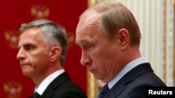 Russian President Vladimir Putin (right) and Swiss President and current OSCE Chairman Didier Burkhalter hold a press conference at the Kremlin in Moscow on May 7.