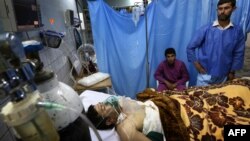 A wounded Iraqi man receives treatment in a hospital following two bombings targeting the country's ethnic Shabak community.