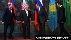Russian Foreign Minister Sergei Lavrov (second from right) jokes with Iranian counterpart Mohammad Javad Zarif (second from left) as Azerbaijan's Elmar Mammadyarov (left) and Kazakhstan's Kairat Abdrakhmanov look on.