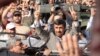 Iranian President Mahmud Ahmadinejad flashes victory signs as he greets Lebanese supporters upon his arrival in Beirut on October 13.
