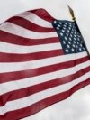Kosovo -- A US Military Cadet holds the US flag during his visit in the town of Ferizaj, June 16, 2015