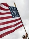 Kosovo -- A US Military Cadet holds the US flag during his visit in the town of Ferizaj, June 16, 2015